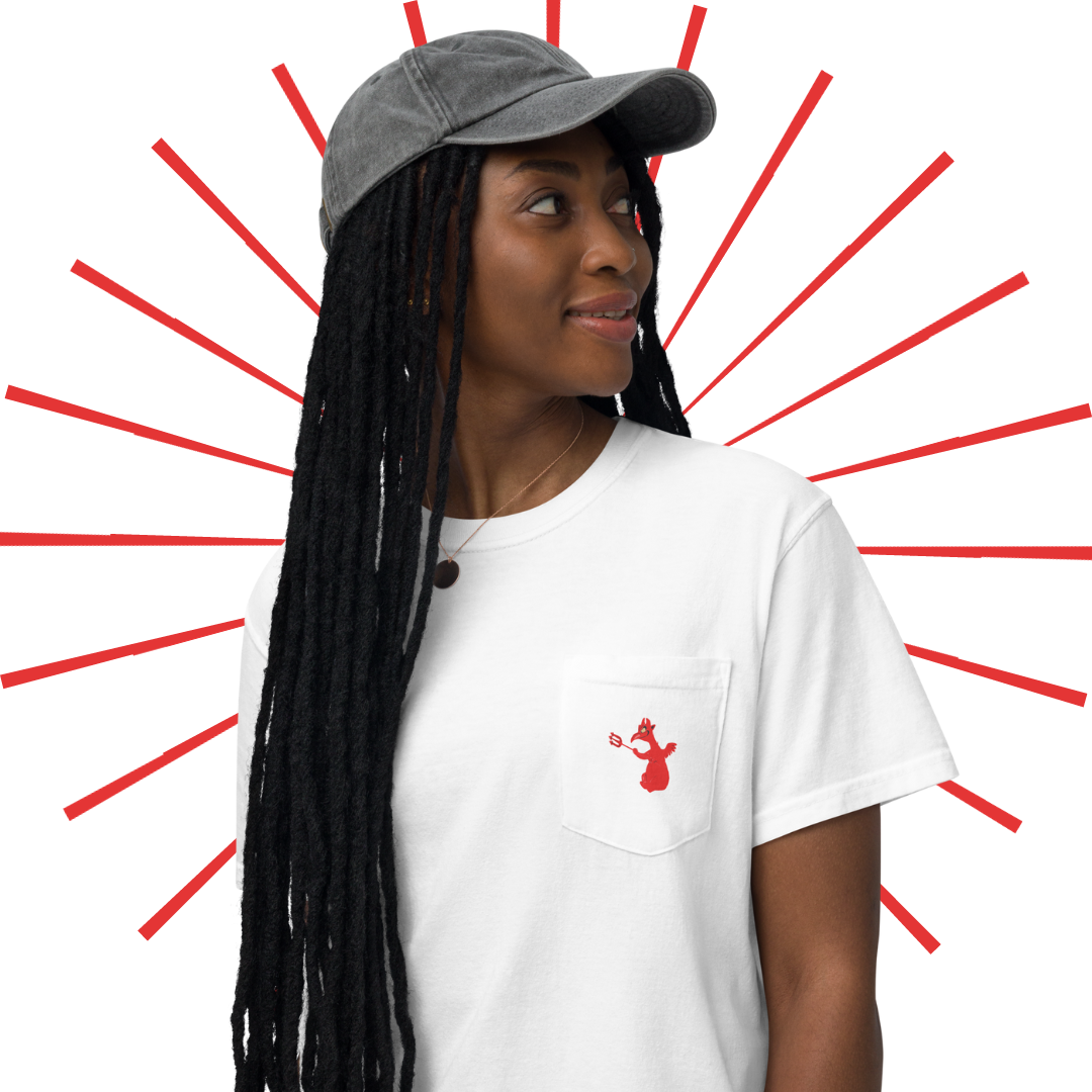 A young, slender black woman with long, extra medium-sized locs. She is wearing a grey, vintage-looking baseball cap and the white "Like, Really Wild" shirt. On the front of the shirt we can see a small pocket on the left hand side of the shirt with the little red devil dude from the Hell scene in Mr. Toad's Wild Ride. She looks past her left shoulder with a slightly pleasant gaze.