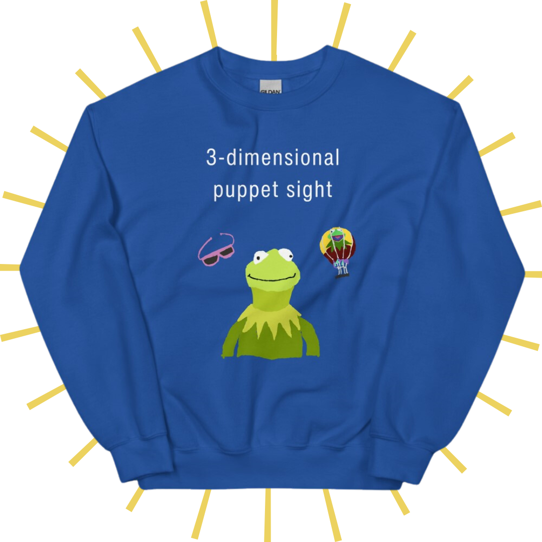 Front side of a bright blue sweatshirt with plain white text reading "3-dimensional puppet sight". Below that are three shakily rendered drawings, as if done on MS Paint. The most prominent drawing in the center is Kermit the Frog from the chest up, with one of his beady eyes slightly askew. To the left of his face is a pair of the pink 3D glasses given to guests at 3-dimensional puppet sight (aka Muppet*Vision 3D). To Kermit's right is a splotchy rendering of the hot air balloon outside the attraction.