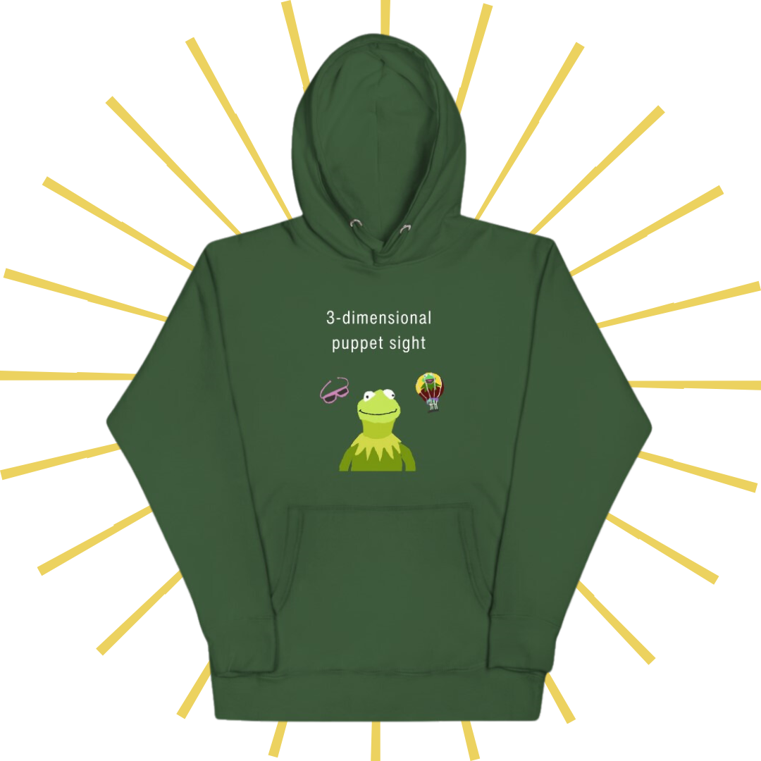 Front side of a green hoodie with plain white text reading "3-dimensional puppet sight". Below that are three shakily rendered drawings, MS Paint style. In the center is Kermit the Frog from the chest up, with one of his beady eyes slightly askew. To the left of his face is a pair of the pink 3D glasses given to guests at 3-dimensional puppet sight (aka Muppet*Vision 3D). To Kermit's right is a splotchy rendering of the hot air balloon outside the attraction. There is also a pouch towards the bottom.