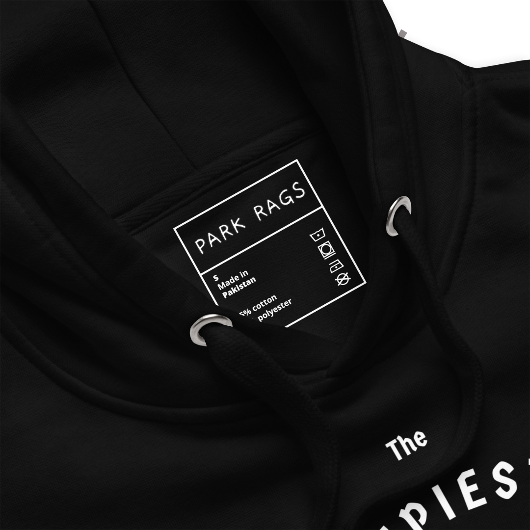 A close-up shot of the inside label of the hoodie. It is printed directly on the garment rather than on a tag. It is a white square containing the Park Rags logo on top, along with the size (S), "Made in Pakistan", laundry symbols for care, and material information. 