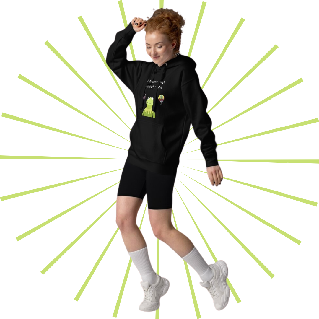 Young, slender Caucasian female with red hair wearing the black version of the hoodie with a pair of black bike shorts, white, shin-high tube socks, and a pair of white sneakers. She faces towards her right side and appears to be dancing.