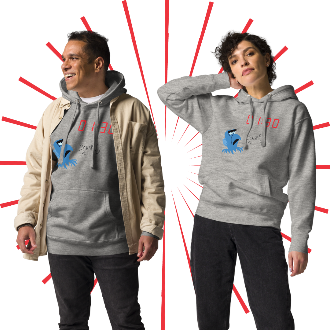 A 30-something man of color with short, brown hair wears the GASP! hoodie in grey, layered with a short, khaki-colored raincoat. Next to him is a Caucasian female with short, curly brown hair wearing the same hoodie in grey.