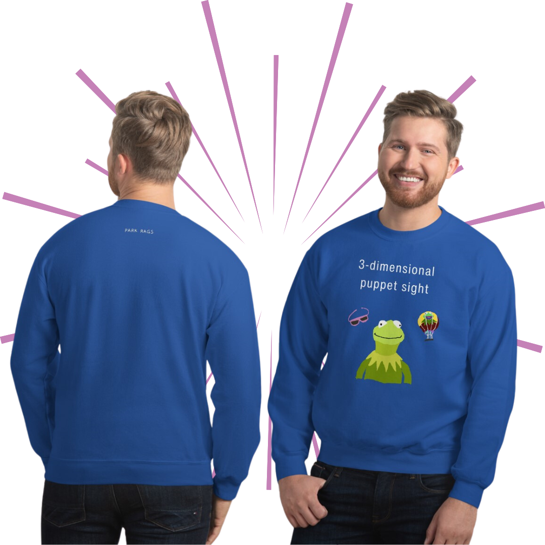 Two shots of an average-sized Caucasian man with short, blonde hair and a beard wearing the 3D Puppet Sight sweatshirt in Royal Blue. On the left, his back is facing the viewer, showing the small white Park Rags logo positioned at the top center of the sweatshirt. On the right, he faces the viewer smiling, with his right thumb tucked into the pocket of his jeans.