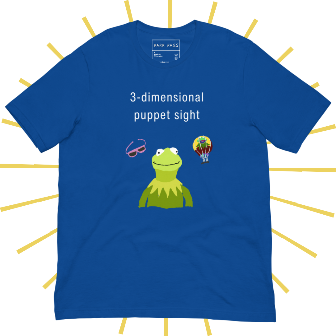 Front side of a bright blue T-shirt with plain white text reading "3-dimensional puppet sight". Below that are three shakily rendered drawings, as if done on MS Paint. The most prominent drawing in the center is Kermit the Frog from the chest up, with one of his beady eyes slightly askew. To the left of his face is a pair of the pink 3D glasses given to guests at 3-dimensional puppet sight (aka Muppet*Vision 3D). To Kermit's right is a splotchy rendering of the hot air balloon outside the attraction.