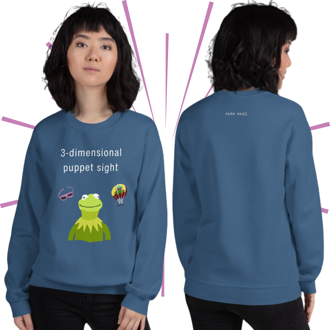 Two shots of a slender Asian woman with wavy, shoulder-length black hair and bangs wearing the 3D Puppet Sight sweatshirt in Indigo Blue. On the left, she faces the viewer with a neutral gaze. On the right, she is turned away from the viewer to show the back of the sweatshirt, which features a small white Park Rags logo at the top center of the sweatshirt.